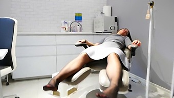 Aroused Fitness Trainer Services Client'S Feet At Gym